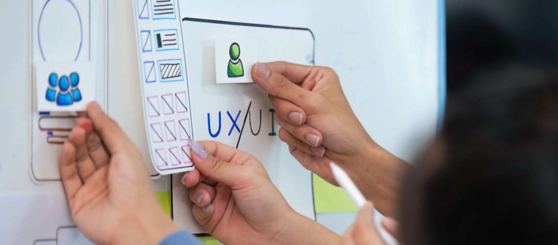 Close up ux developer and ui designer use augmented reality brainstorming about mobile app interface wireframe design on desk at modern office. creative digital development agency.