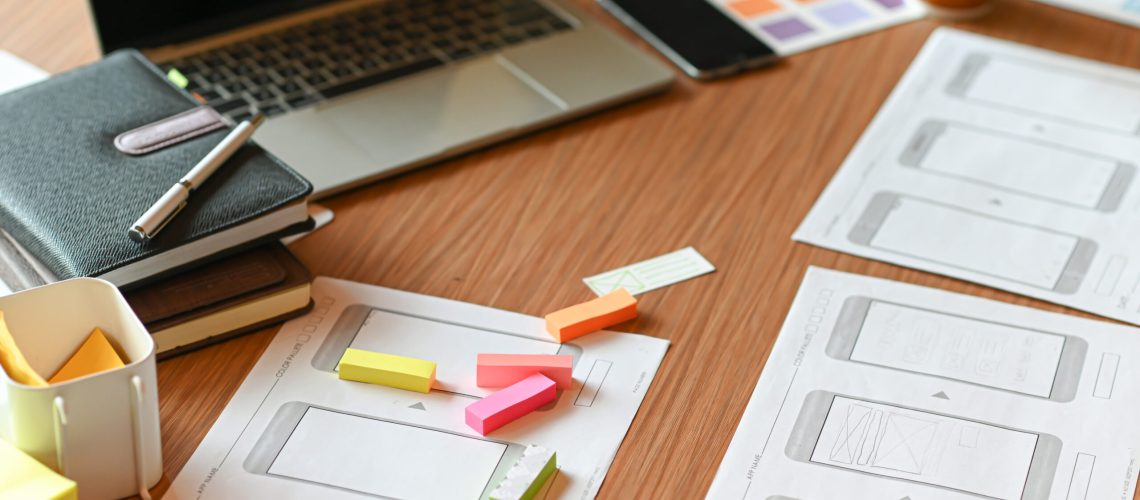 Designer desk space for designers. Color charts, model phones and tablet.