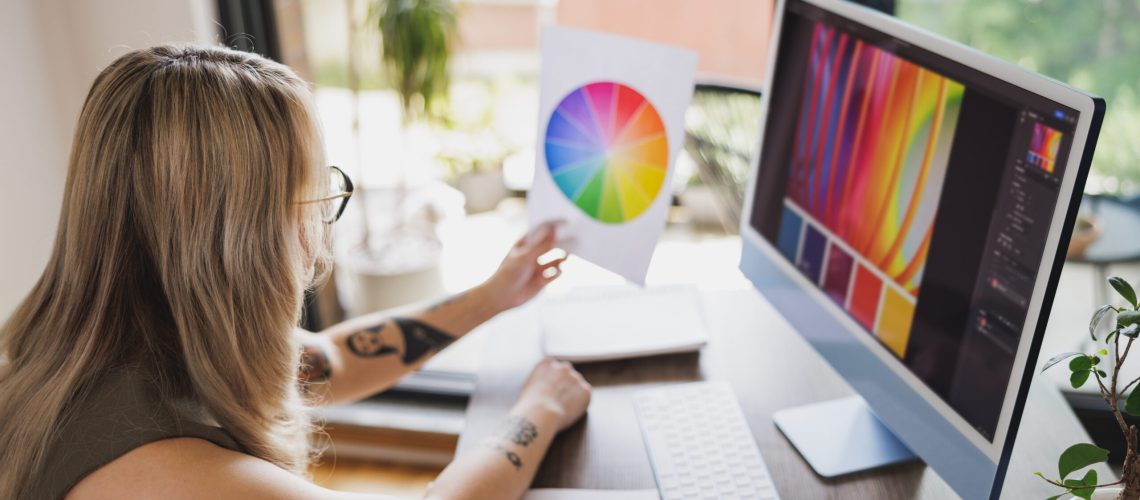 Creative young woman working on computer in her home studio.