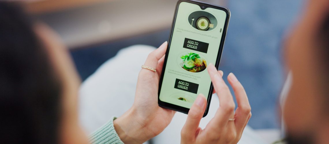 Hands, home and couple with menu, smartphone and order food with digital app, connection and networ.