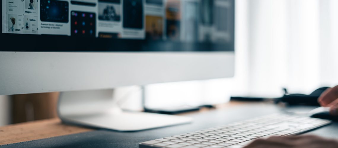 Man working on computer desk and smartphone at home office