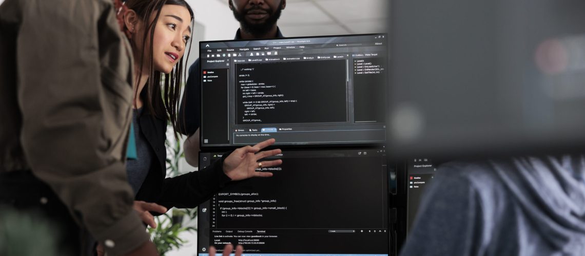 Team of system engineer writing data and discussing about coding language, analyzing server code and database. IT engineers working with cloud computing terminal window in software company
